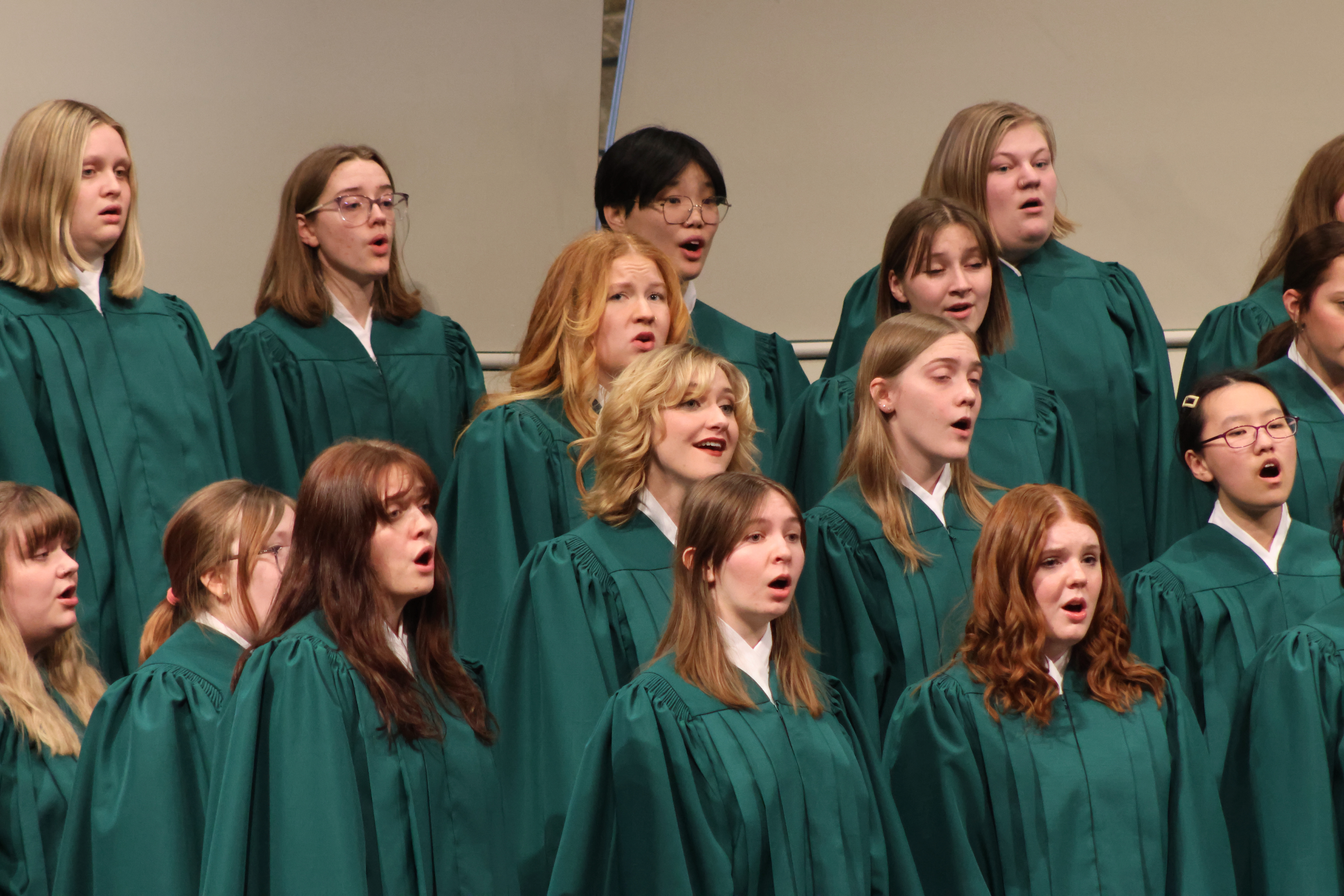 The Lucia Singers performing in their traditional green choir robes.