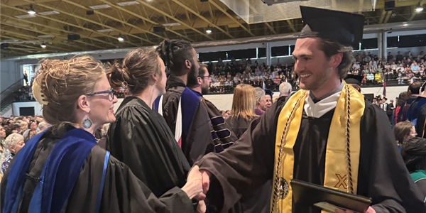 Commencement2025 graduate shaking hands