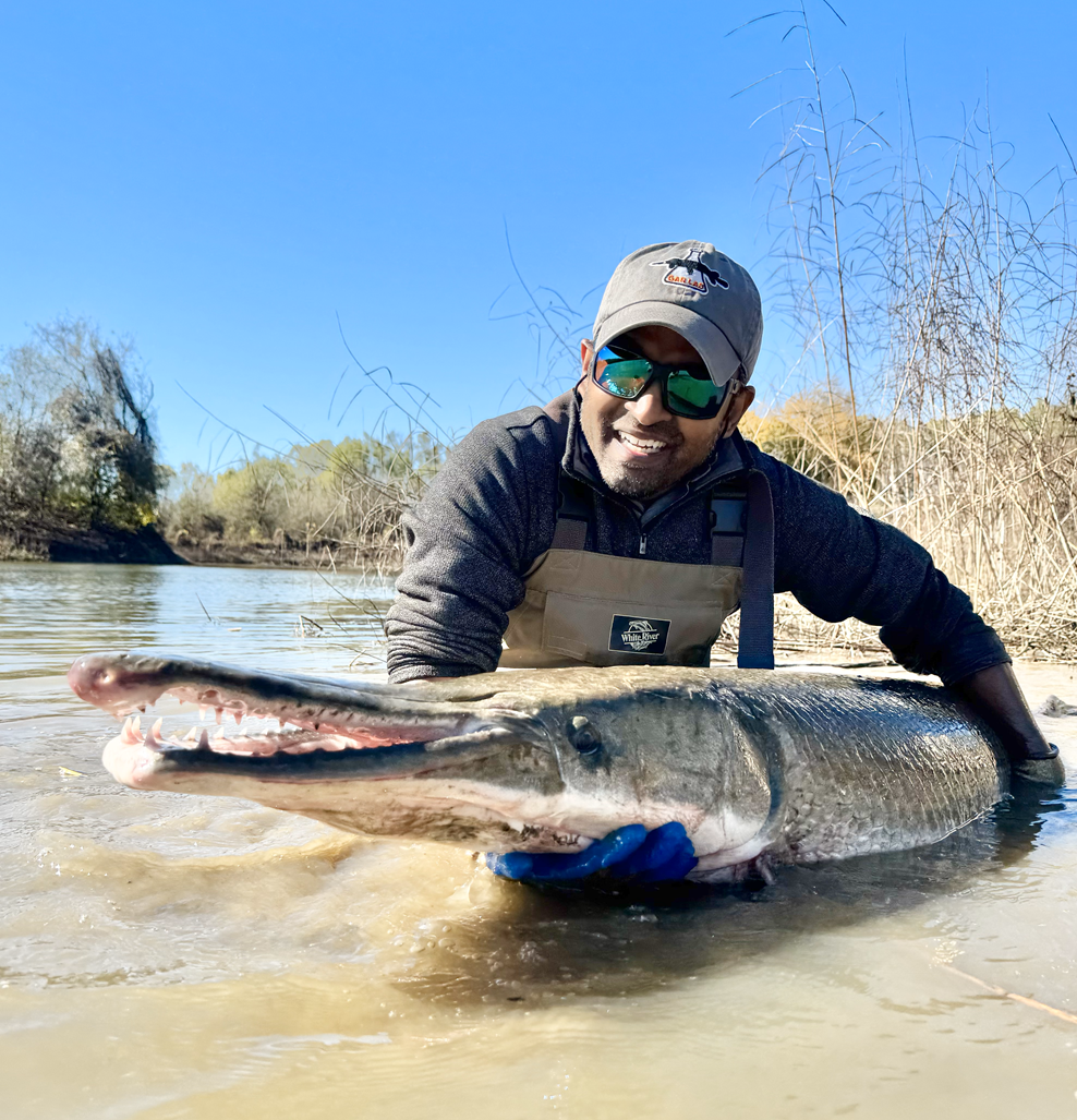 Solomon R. David holidng an alligator gar fish