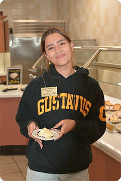 Student in dining room with dessert