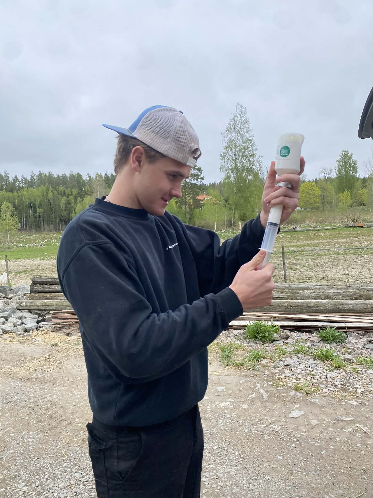 student Carl Shobe prepping antibiotics on a farm