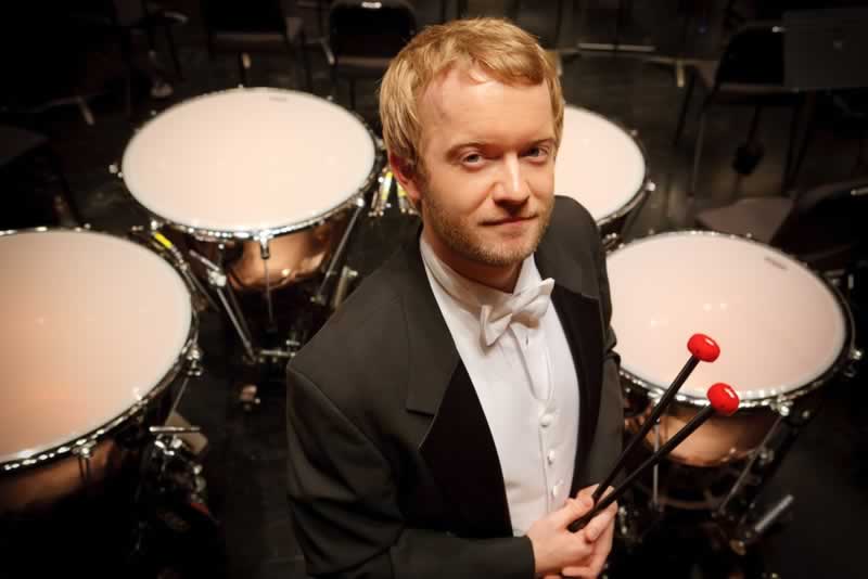 Jason Haaheim, principal timpanis for the MET, stands in front of his four timpani.