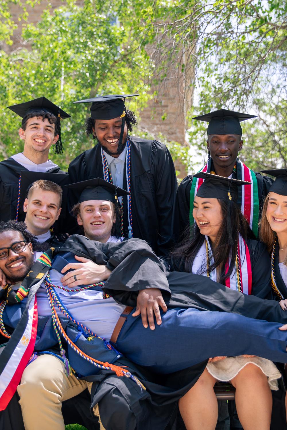 graduates in group photo with caps and gowns on