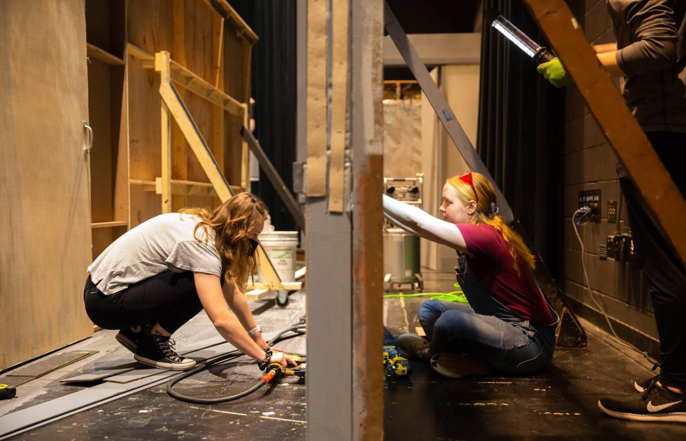 Students work on a theater set. 