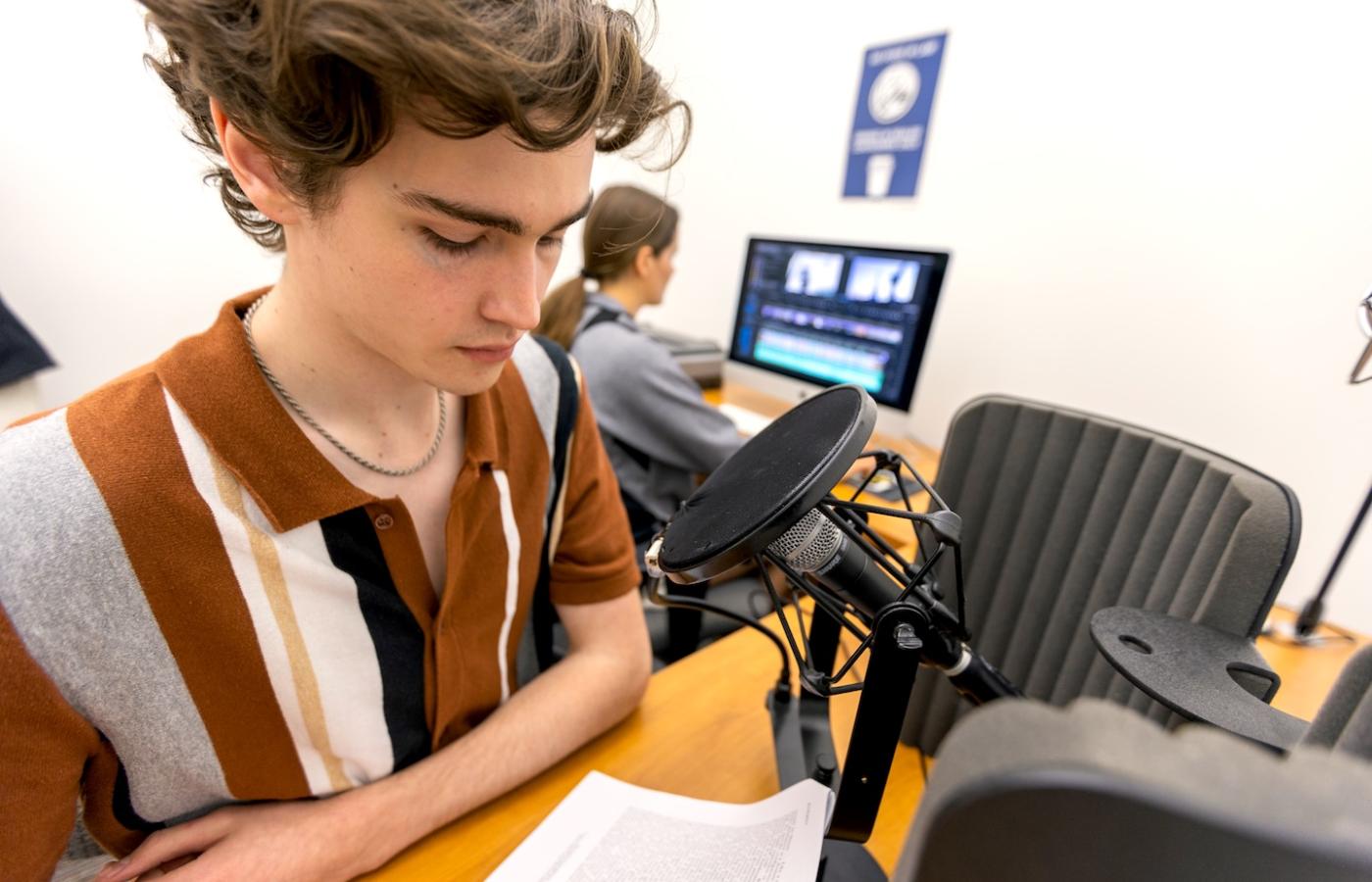 A student works on a podcast. 