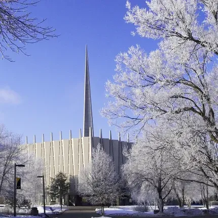 Christ Chapel during the winter with frosted trees and a blue sky