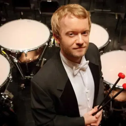 Jason Haaheim, principal timpanis for the MET, stands in front of his four timpani.