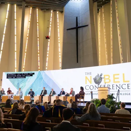 Nobel Conference panelists on stage in Christ Chapel