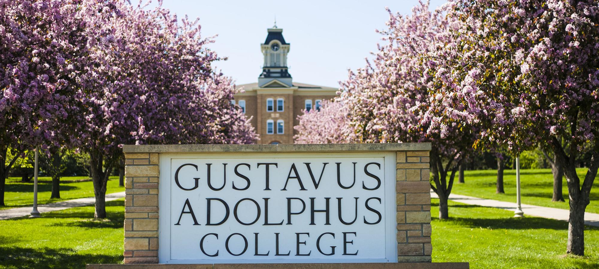 Gustavus sign with trees blooming