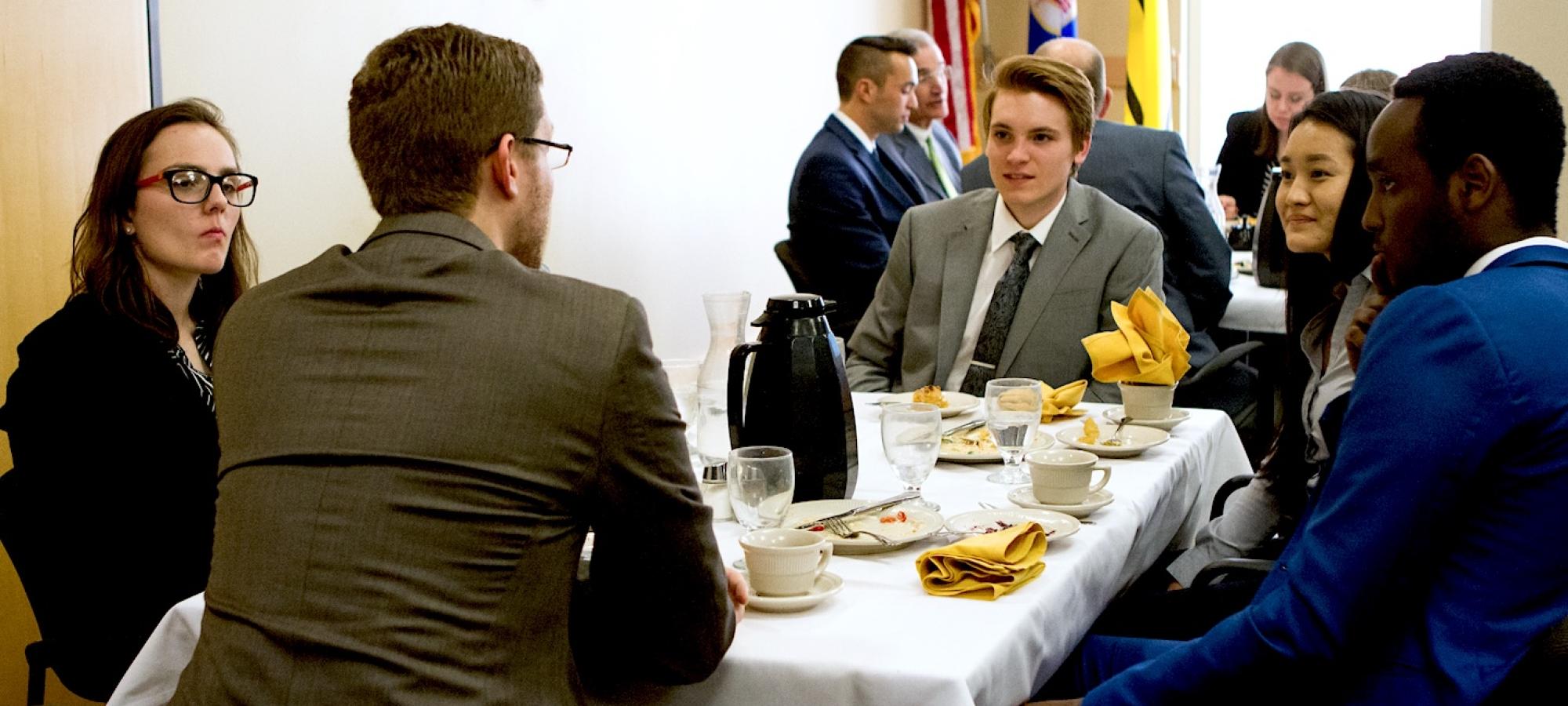 Students speak to a mentor at an event. 
