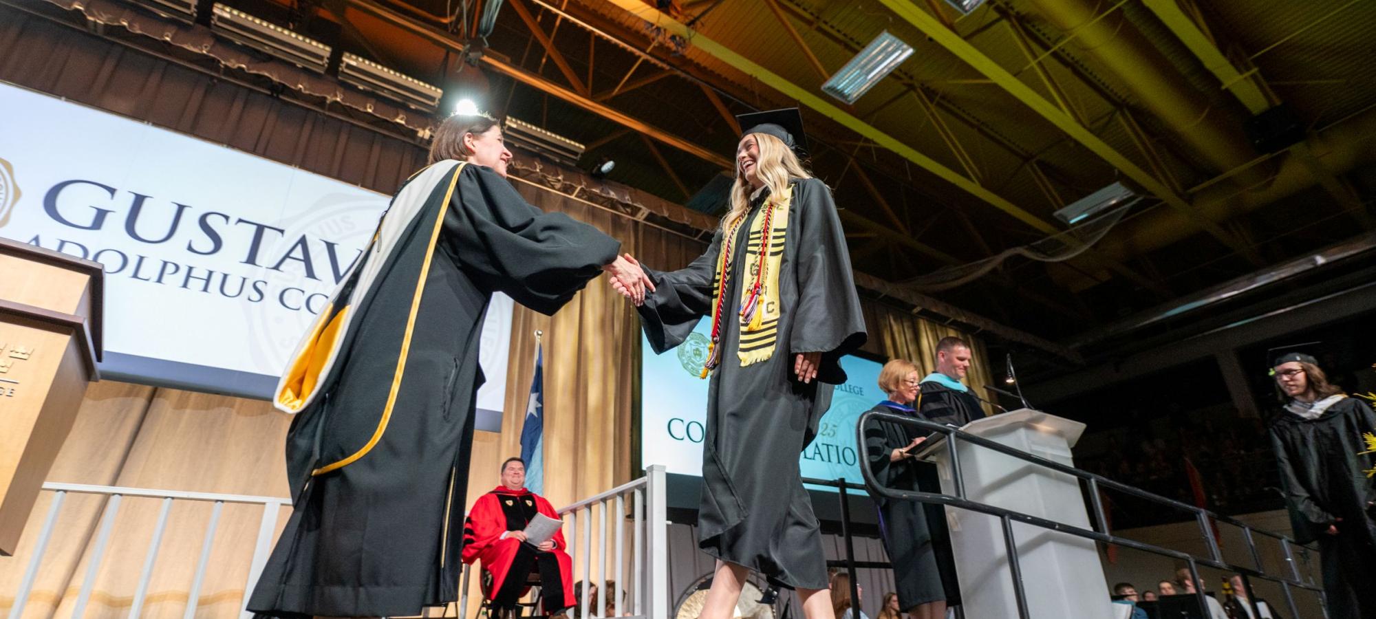 Commencement student crossing stage