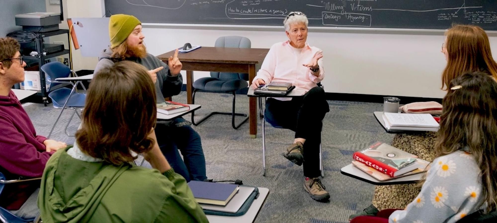 A Gustavus Adolphus College philosophy professor discusses with her students. 