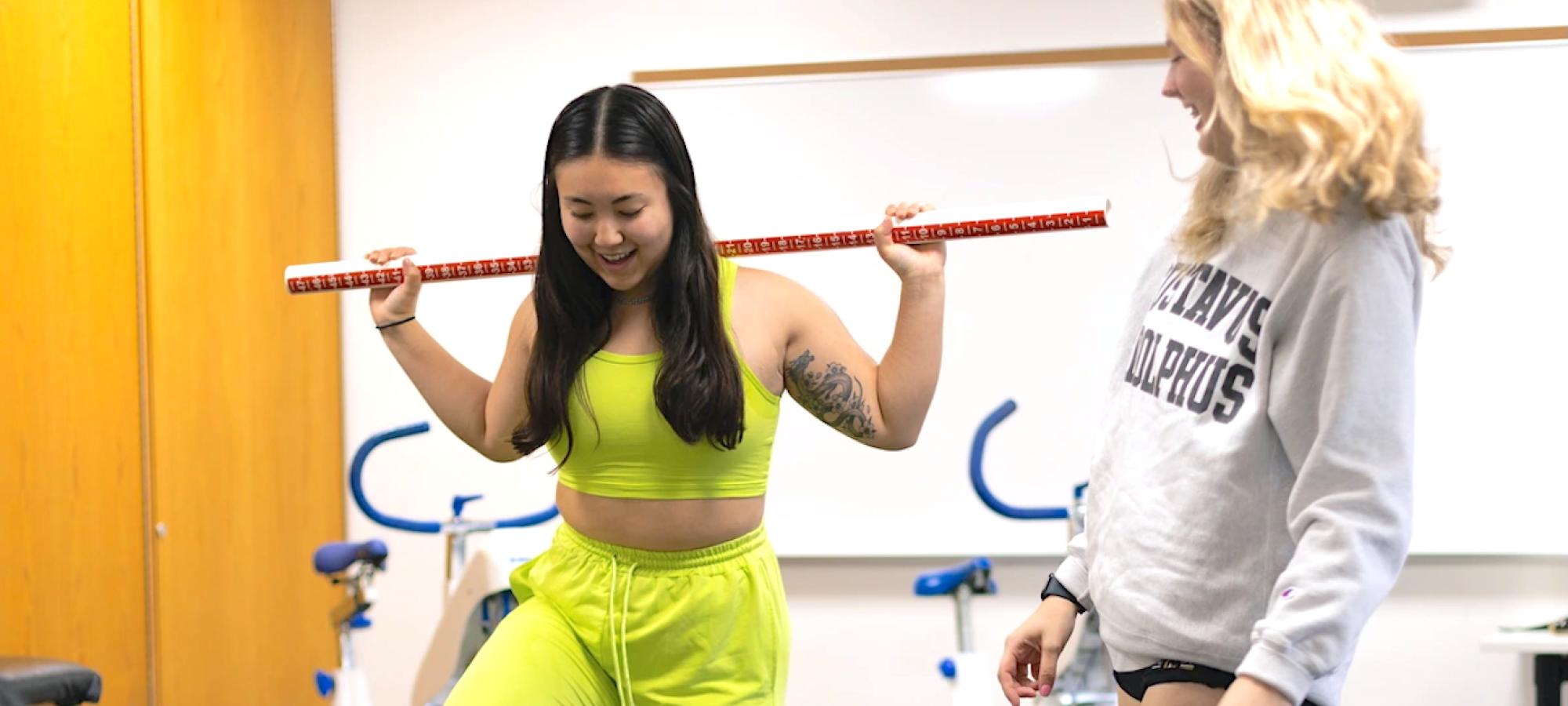 Two women work on an exercise together.