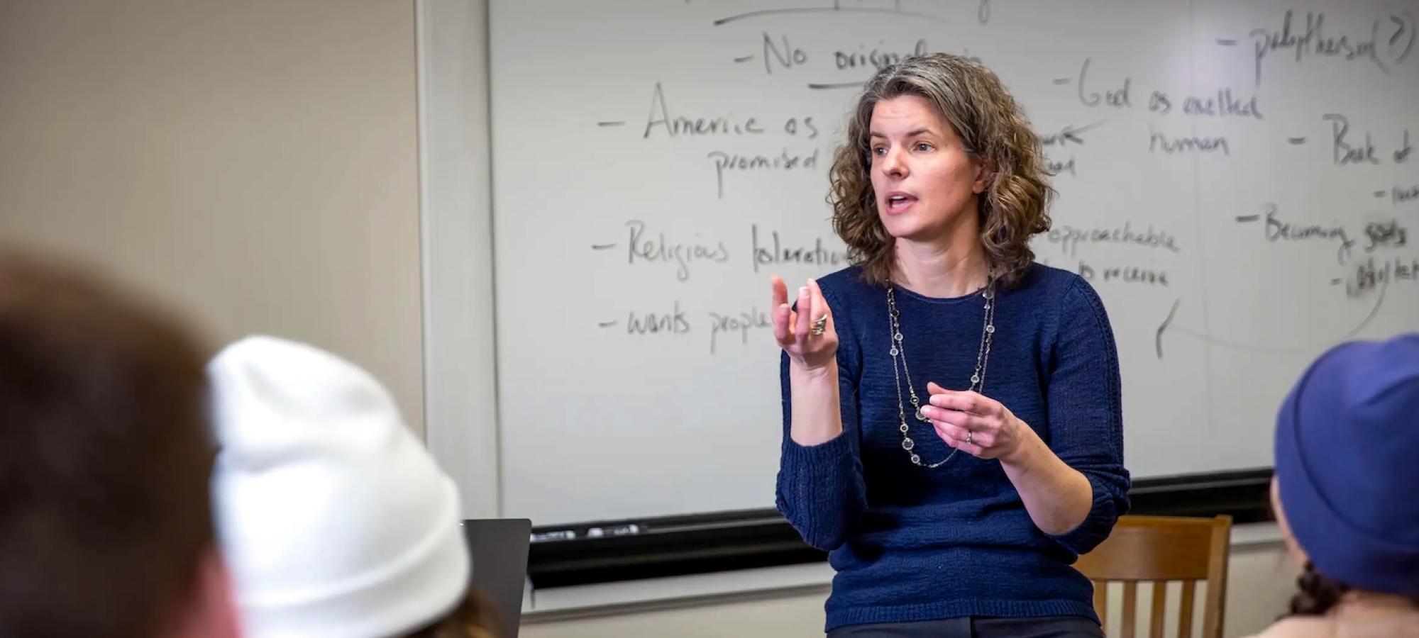 A Gustavus Adolphus College professor makes a point by gesturing. 