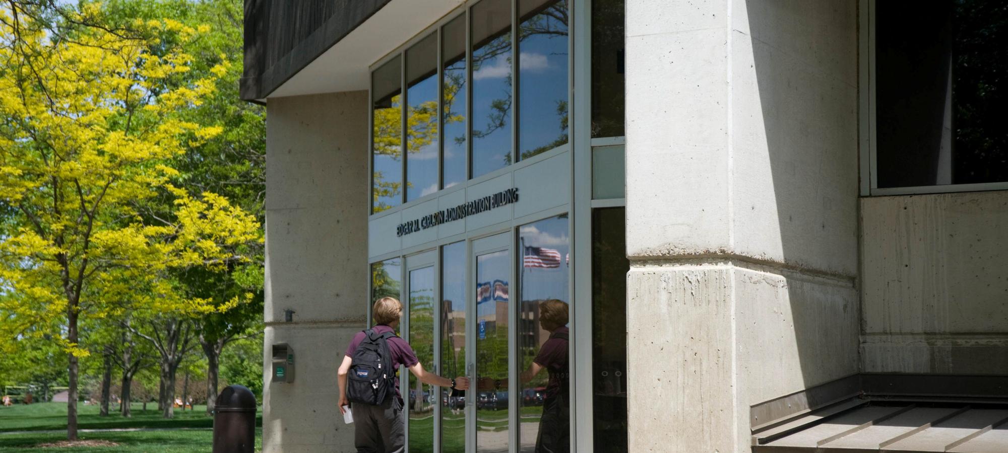 student entering administration building