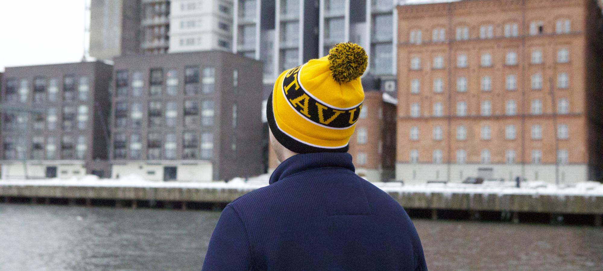 A man on a boat looks at Stockholm from the water. 