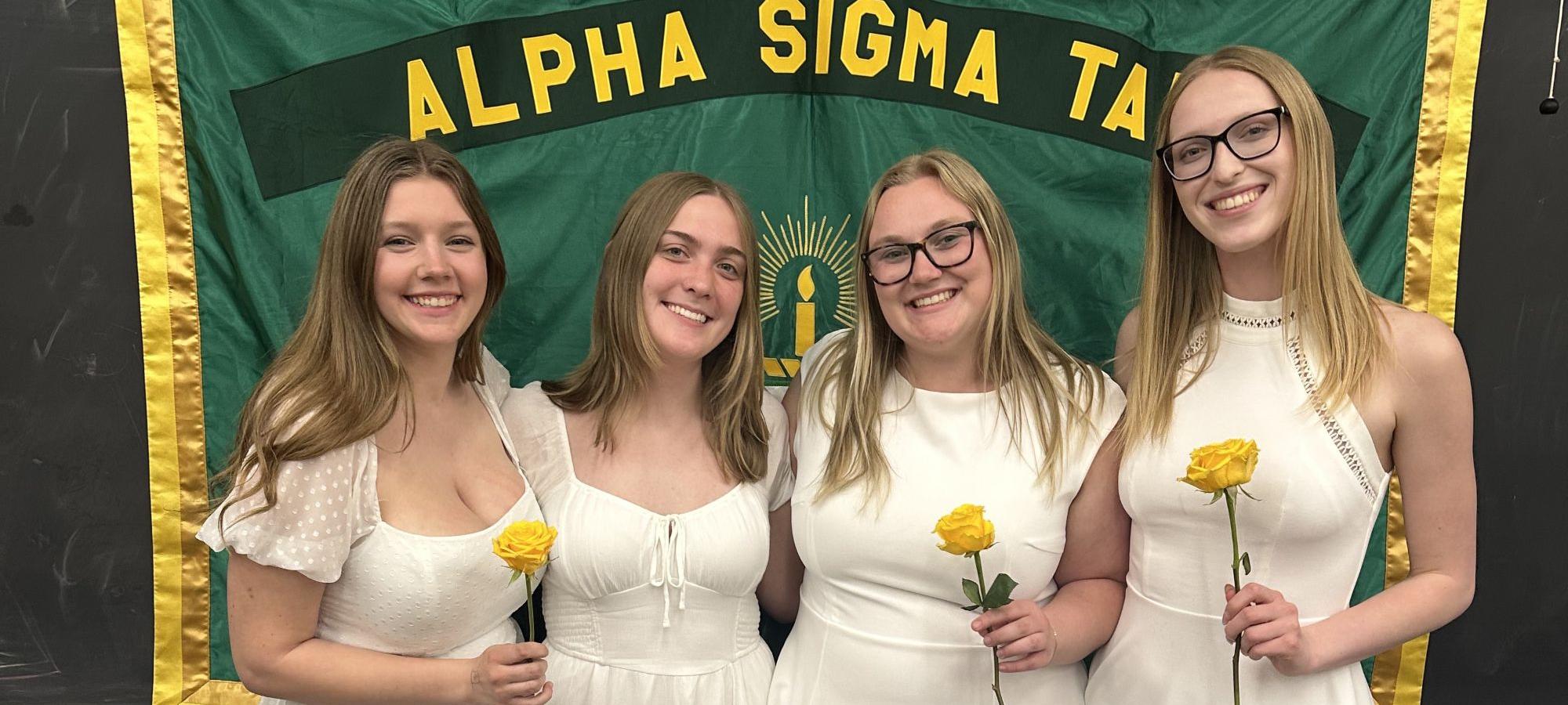 Alpha Sigma Tau members with flowers