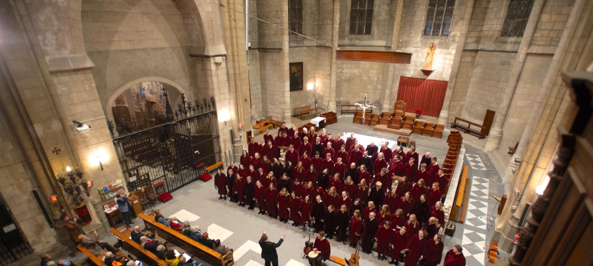 A choir performs in a grand cathedral.
