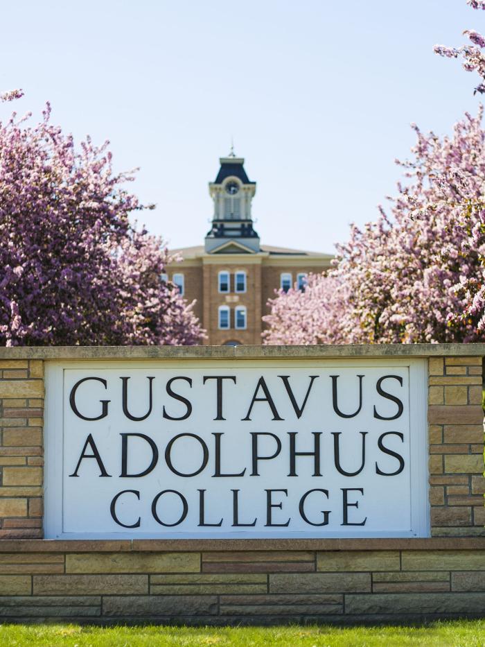 Gustavus sign with trees blooming