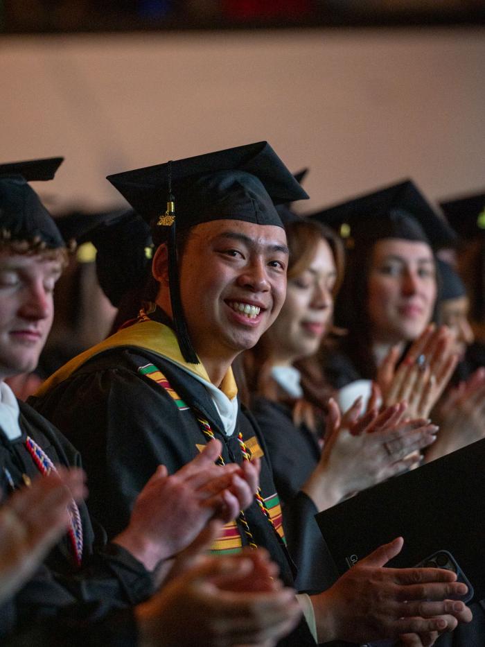 Commencement smiling student at ceremony