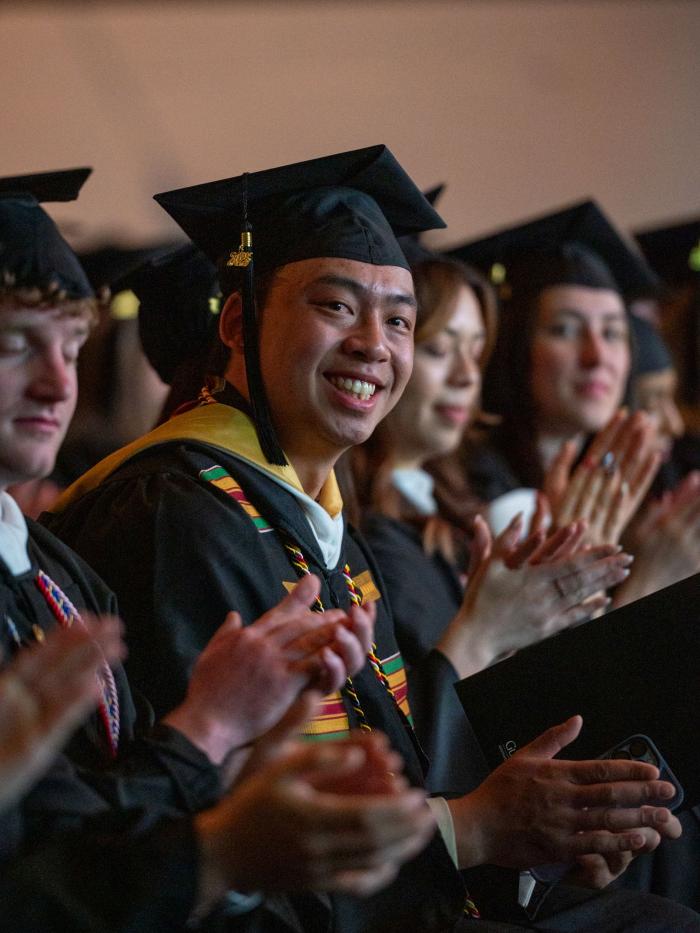 Commencement smiling student at ceremony