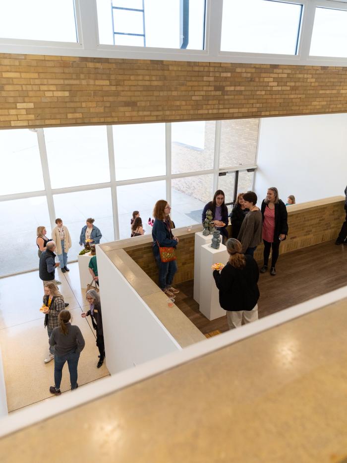 People take in art at a multilevel gallery at Gustavus Adolphus College. 