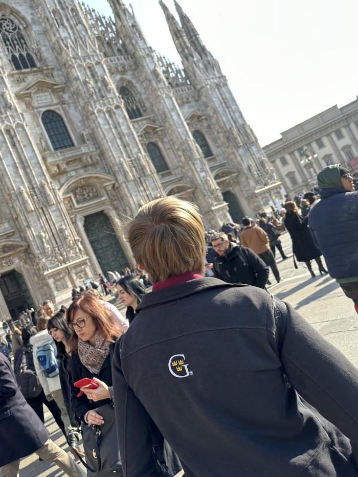 A young man looks at the Duomo in Milan.