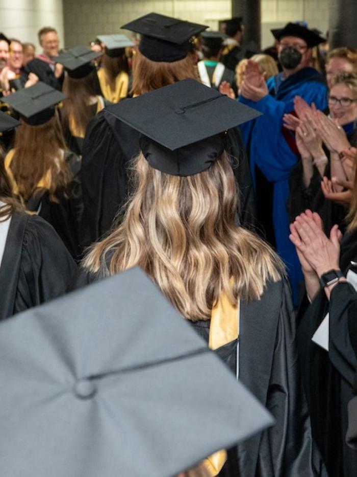 Graduates of Gustavus Adolphus College are applauded by their professors. 