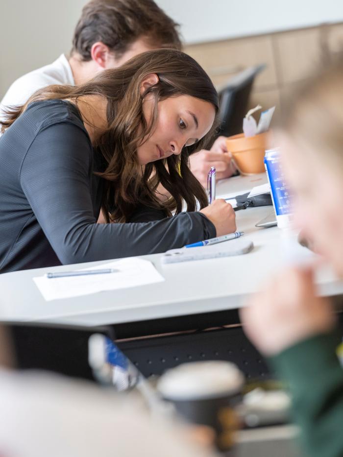 Student writing in class