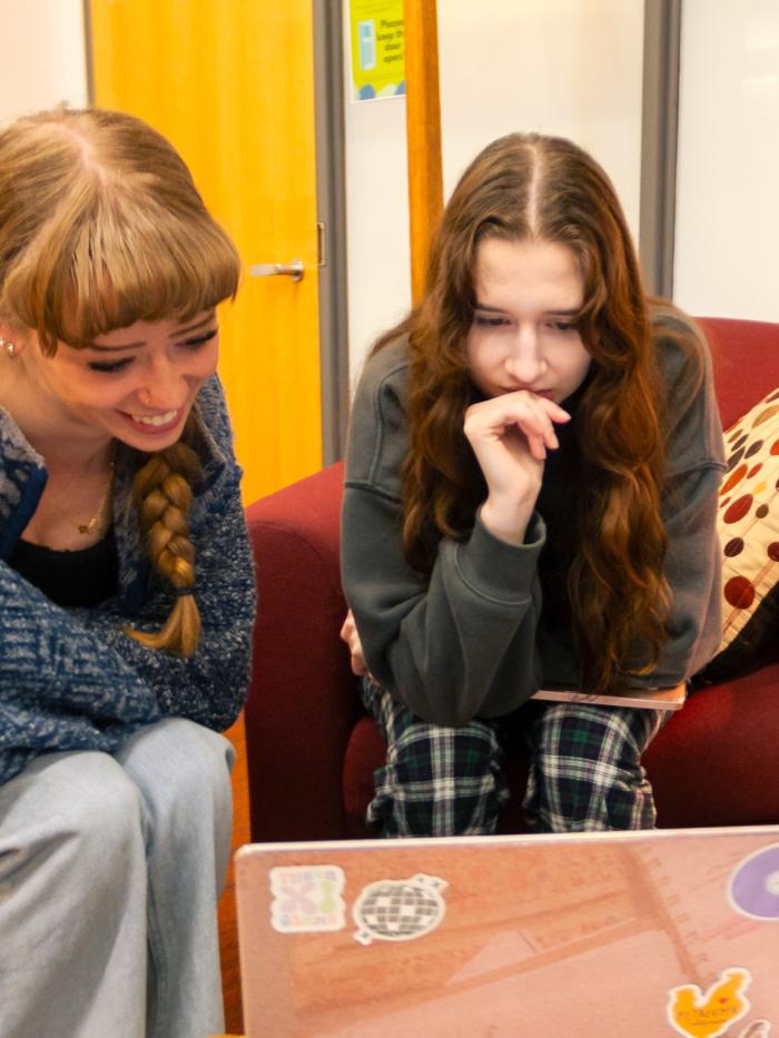 Students look at a computer screen. 