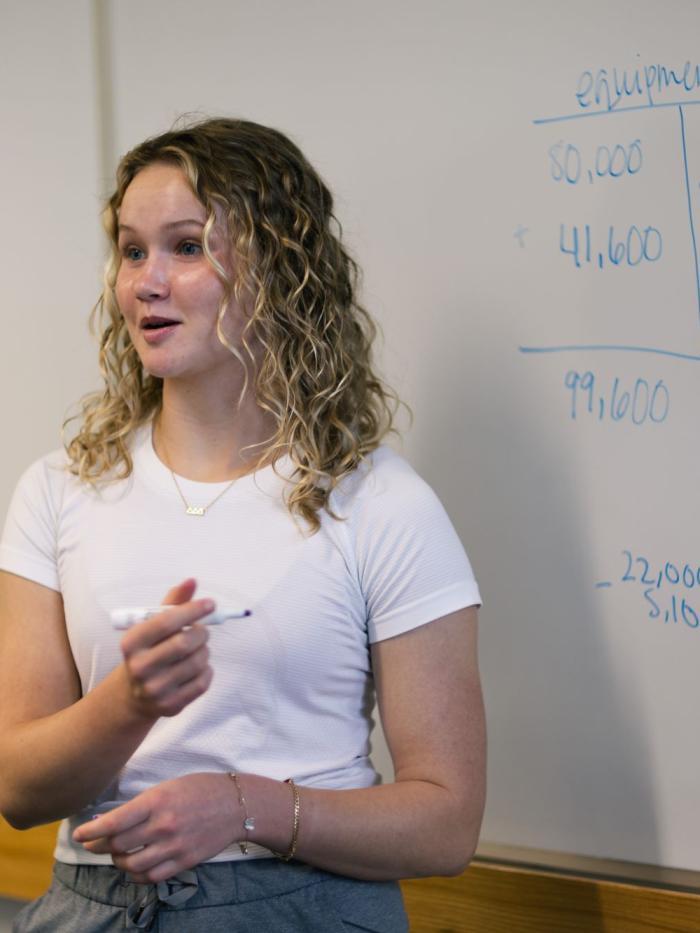 Accountng student at board