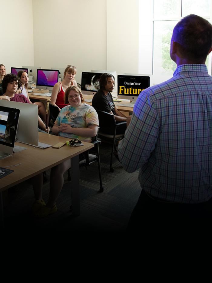 Professor and students in computer lab, lecture