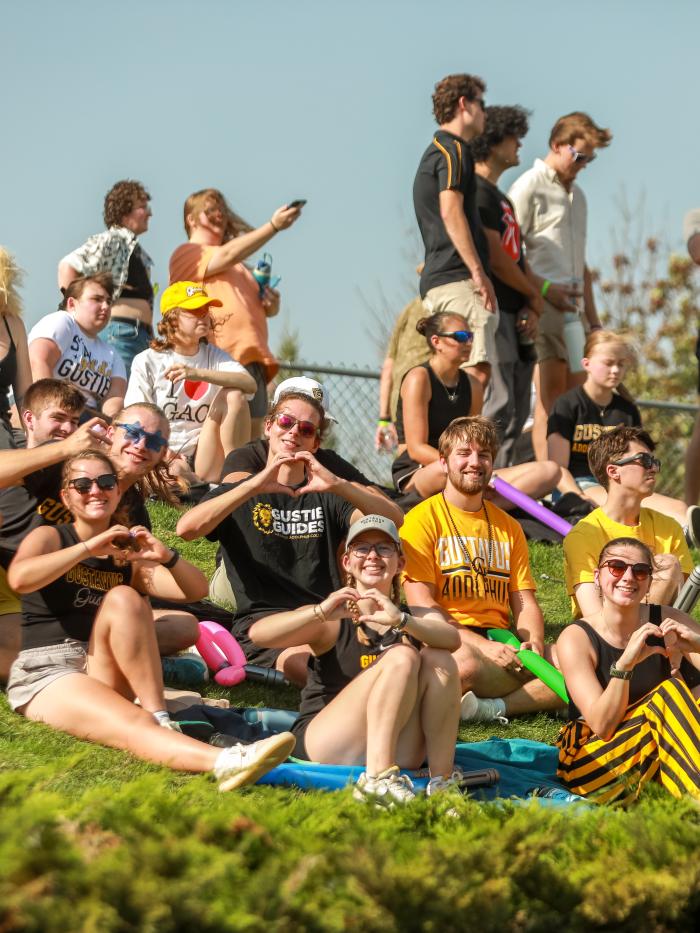 students on hill at game