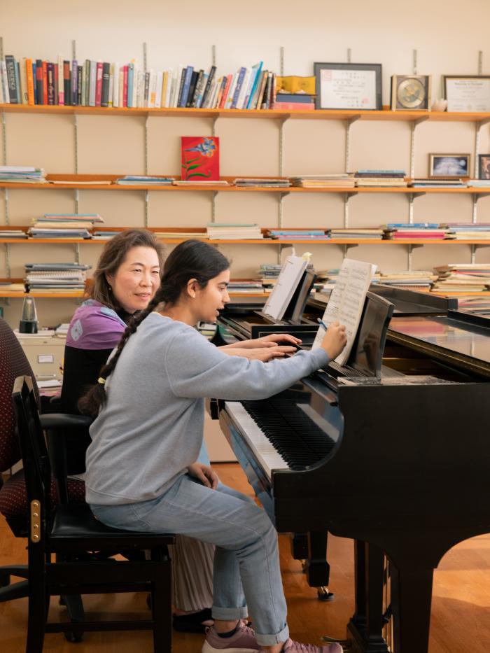 student and teacher at piano