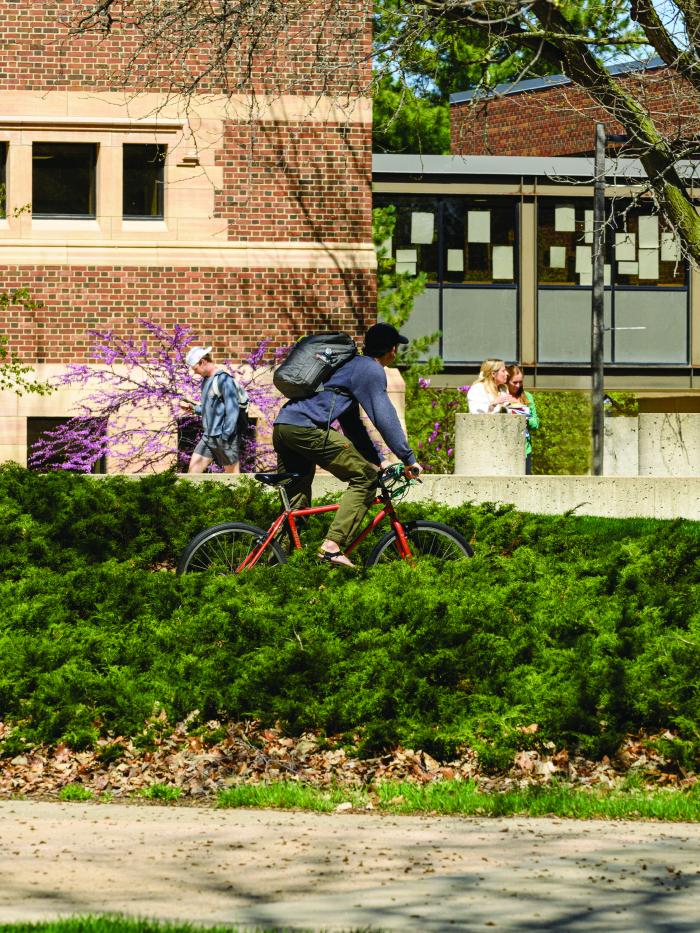 student biking on campus