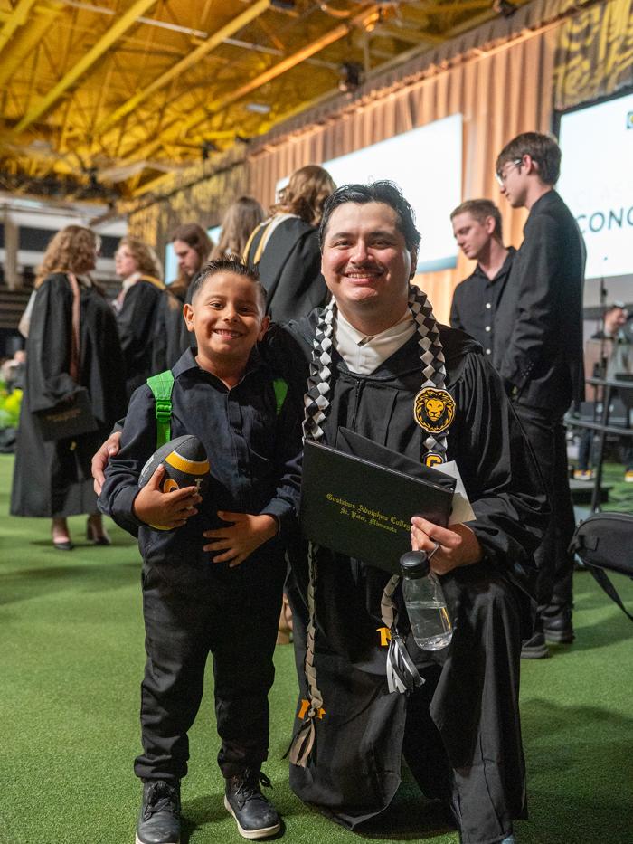2026 grad with future Gustie holding football