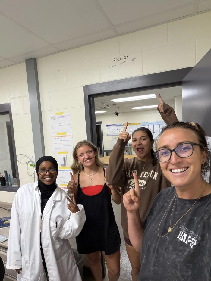students and advisor in science lab