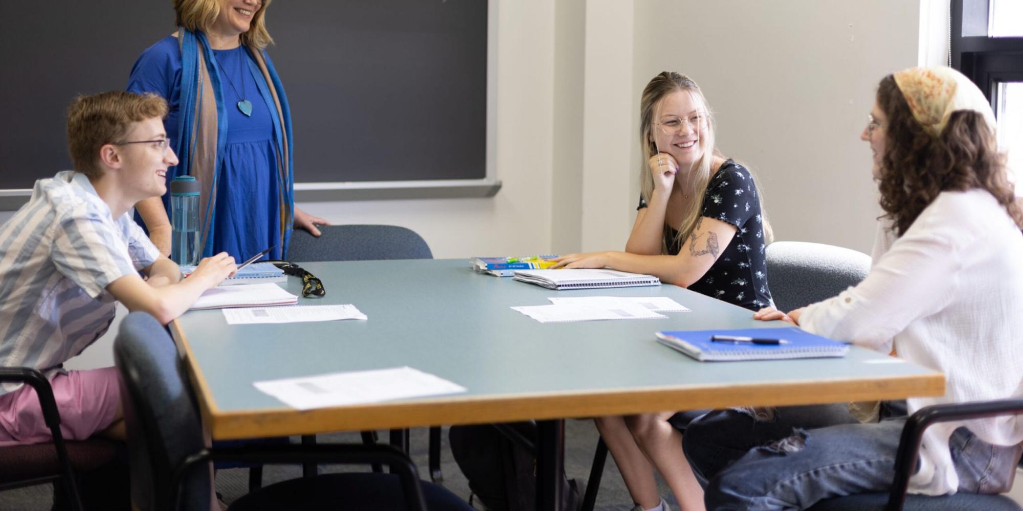 Scandinavian Studies professor chats with students in classroom setting